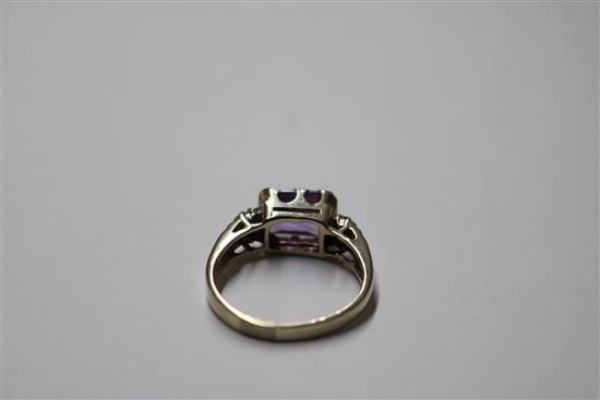 An 18ct white gold and emerald cut amethyst ring with diamond set shoulders, size P.